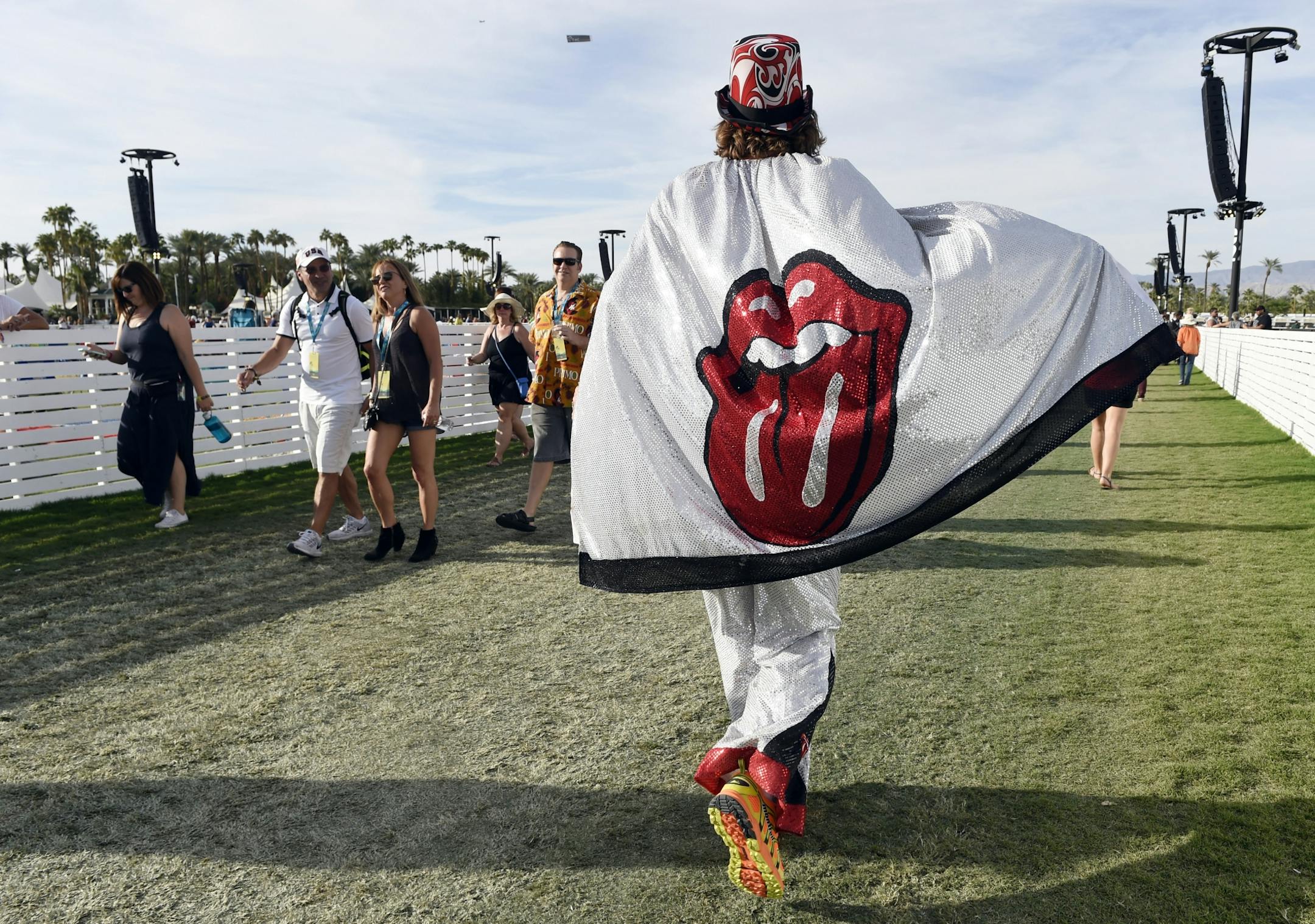 Rolling Stones fan Warner Munro of Portland, Ore., walks through the Empire Polo Field on day 1 of the 2016 Desert Trip music festival on Friday, Oct. 7, 2016, in Indio, Calif.