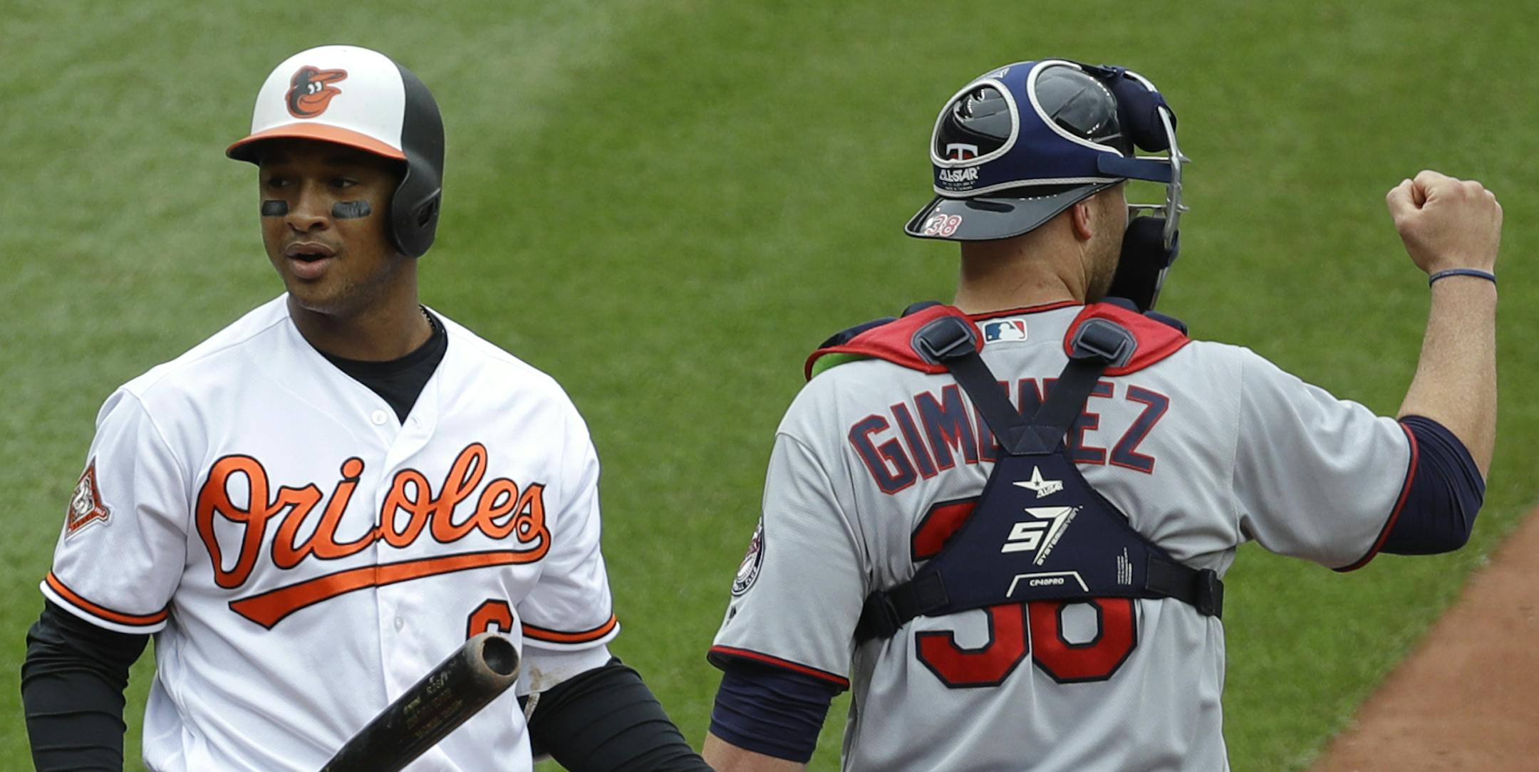 Baltimore Orioles' Jonathan Schoop, left, reacts in front of Minnesota Twins catcher Chris Gimenez after striking out swinging with the bases loaded to end the fourth inning of a baseball game in Baltimore, Wednesday, May 24, 2017. (AP Photo/Patrick Semansky)