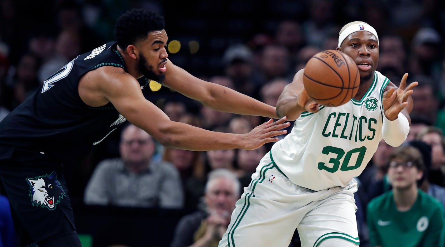 Celtics forward Guerschon Yabusele passes the ball as he is pressured by Timberwolves center Karl-Anthony Towns on Wednesday in Boston.