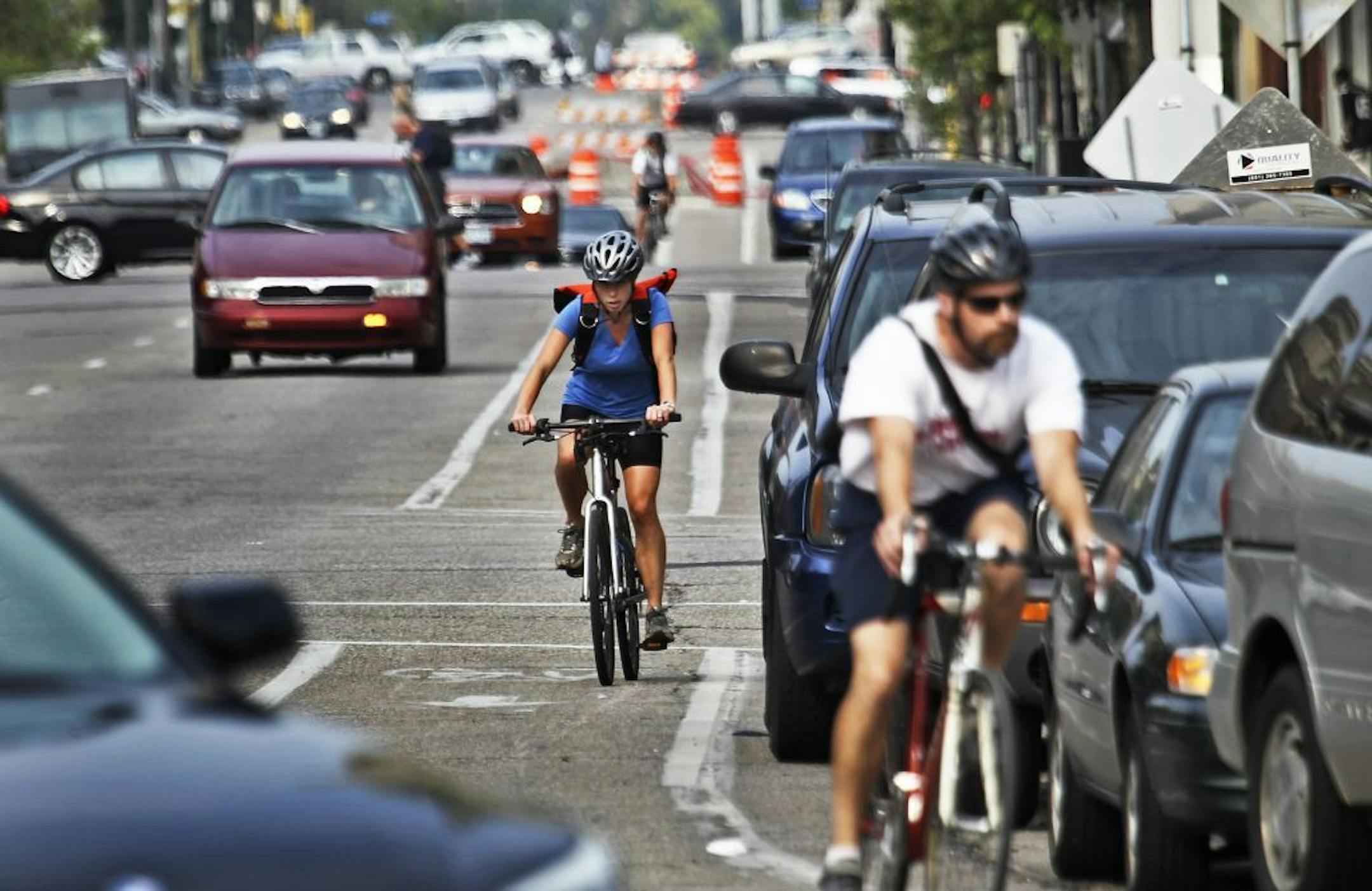 Bicyclists and cars co-exist while heading south in heavy traffic along Portland Ave., near E. Grant Street Thursday, Aug. 30, 2012, in Minneapolis, MN.