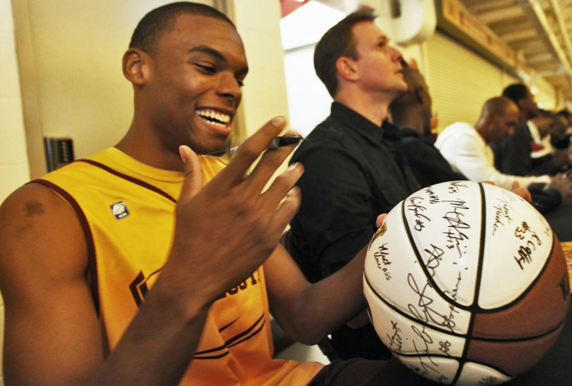 UM Gophers basketball team opened their season with a skills and scrimmage session Friday night. Gophers freshman Andre Hollins, left signed autographs.