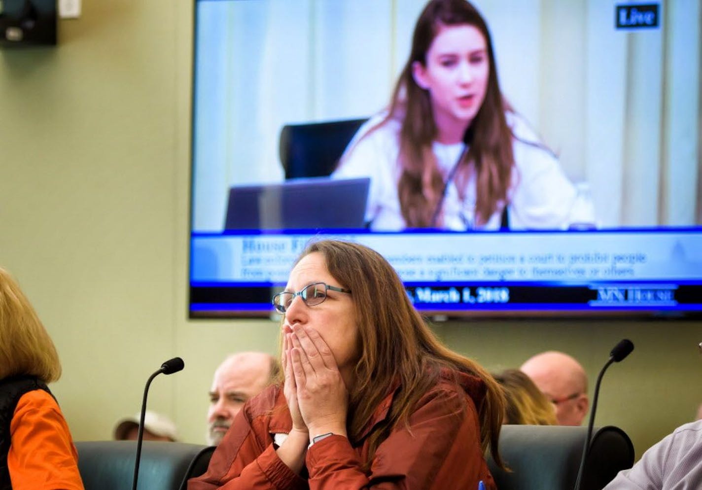 Caren Gallagher listened as high school junior Eva Goldfarb spoke about the fear that students experience in school from the threat of guns. Advocates on both sides of the gun rights issue gathered at the Capitol as two gun control measures were introduced on Thursday but the GOP-led committee voted to table both bills.