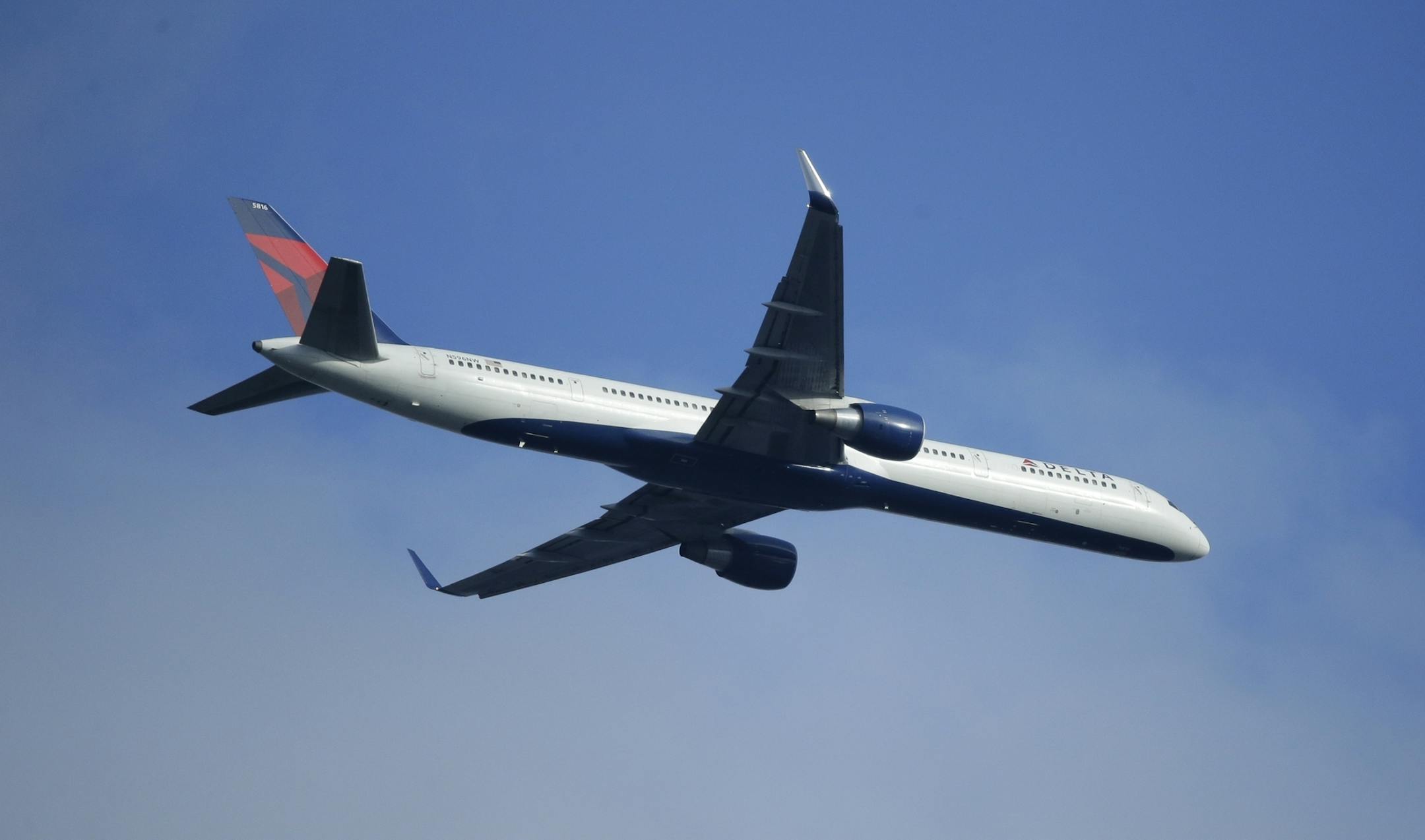 A Delta Air Lines Boeing 757 flies overhead, in Seattle.