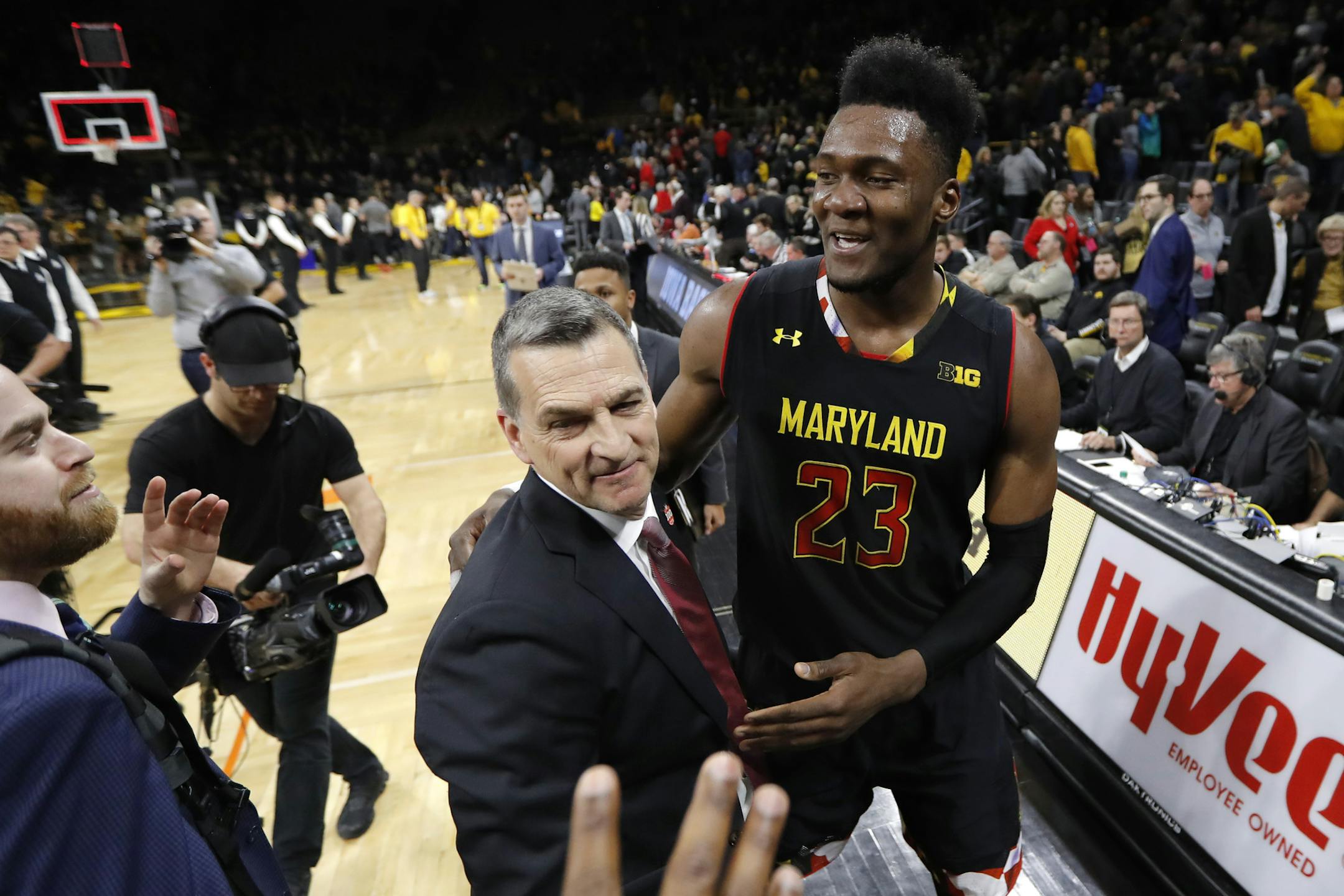 Maryland forward Bruno Fernando (23) celebrates with coach Mark Turgeon after an NCAA college basketball game against Iowa, Tuesday, Feb. 19, 2019, in Iowa City, Iowa. Maryland won 66-65. (AP Photo/Charlie Neibergall)
