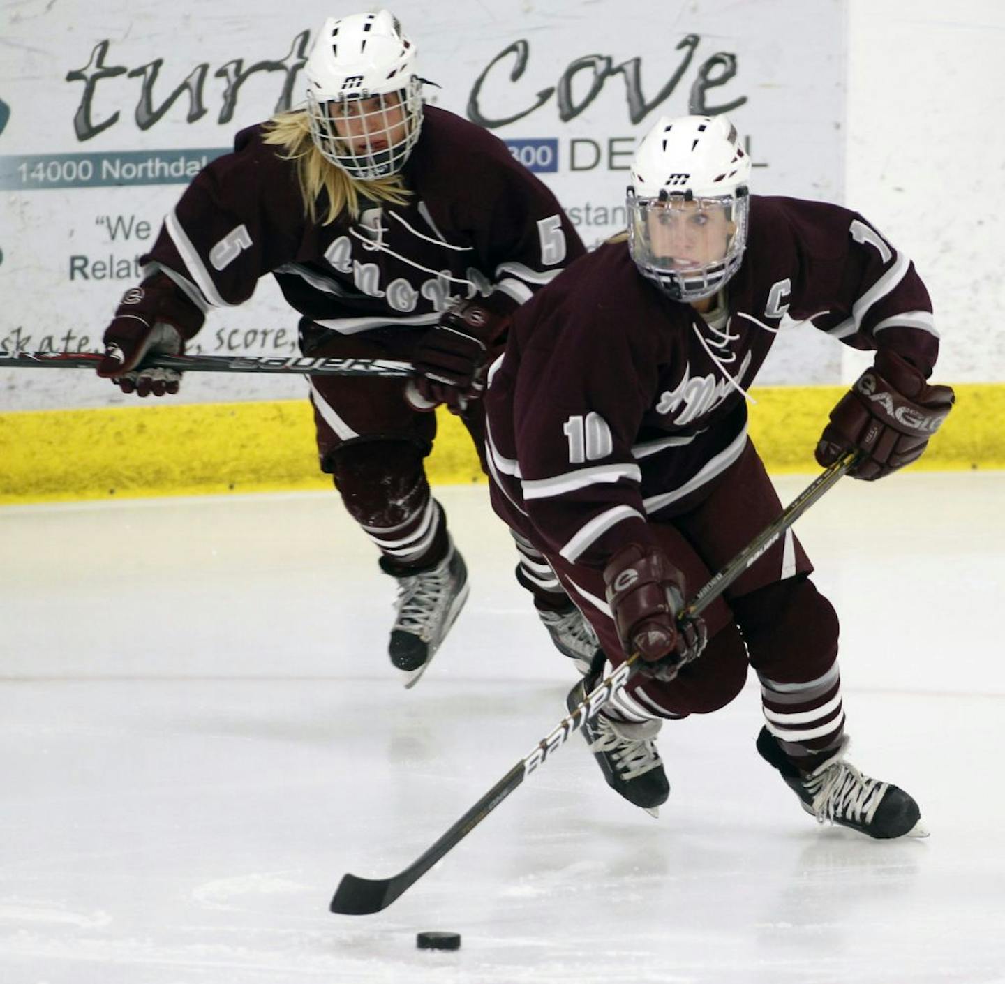 Anoka's McKenna Parent (5) and Katie Johnson(10) move up ice in a recent game against Rogers.