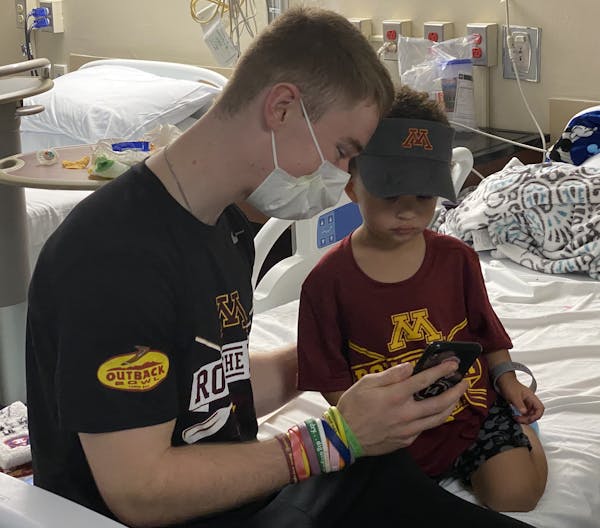 Once Casey O’Brien was lured to Elias McNeal’s room by a “Go Gophers” shout, he spent some time with the toddler.