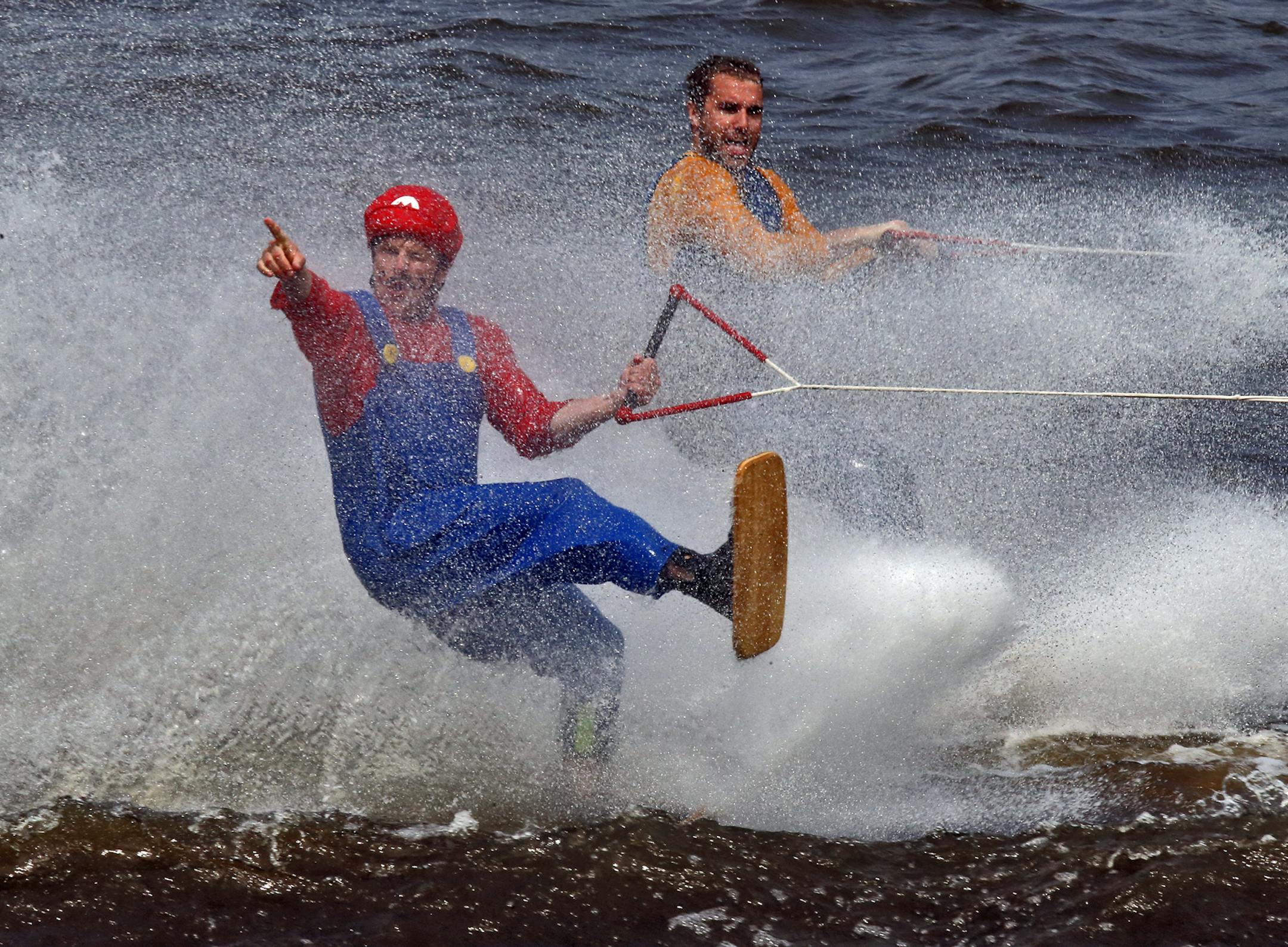 The Twin Cities River Rats Ski Team performed a 'Super Mario World' water ski show on the Mississippi River in downtown Minneapolis Saturday. Towering pyramids, ramp jumpers and barefoot skiers were all part of the program free to the public. Mario characters Abe Cass, left, and Jeremy Tummel performed. (MARLIN LEVISON/STARTRIBUNE(mlevison@startribune.com