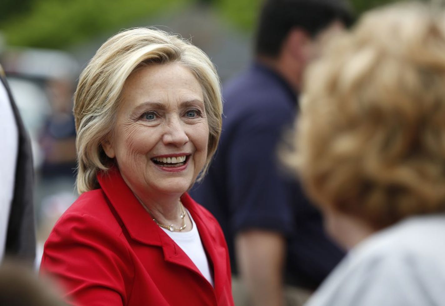 Democratic presidential candidate Hillary Rodham Clinton greets a spectator at a Fourth of July parade. In Minnesota, Clinton has outpaced her competitors in campaign donations by raising nearly $556,000 as of July 2015. The closest any of her competitors have raised is $49,411 by republican presidential candidate Ben Carson.