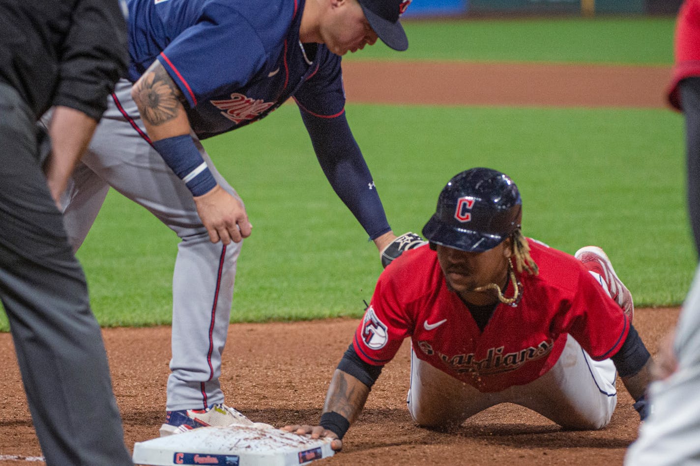 Jose Ramirez gets back to first base ahead of the tag by the Twins' Jose Miranda during the fourth inning Friday