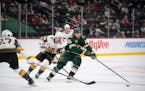 Minnesota Wild defenseman Jonas Brodin (25) controlled the puck coming across the blue line trailed by Vegas Golden Knights right wing Reilly Smith (1