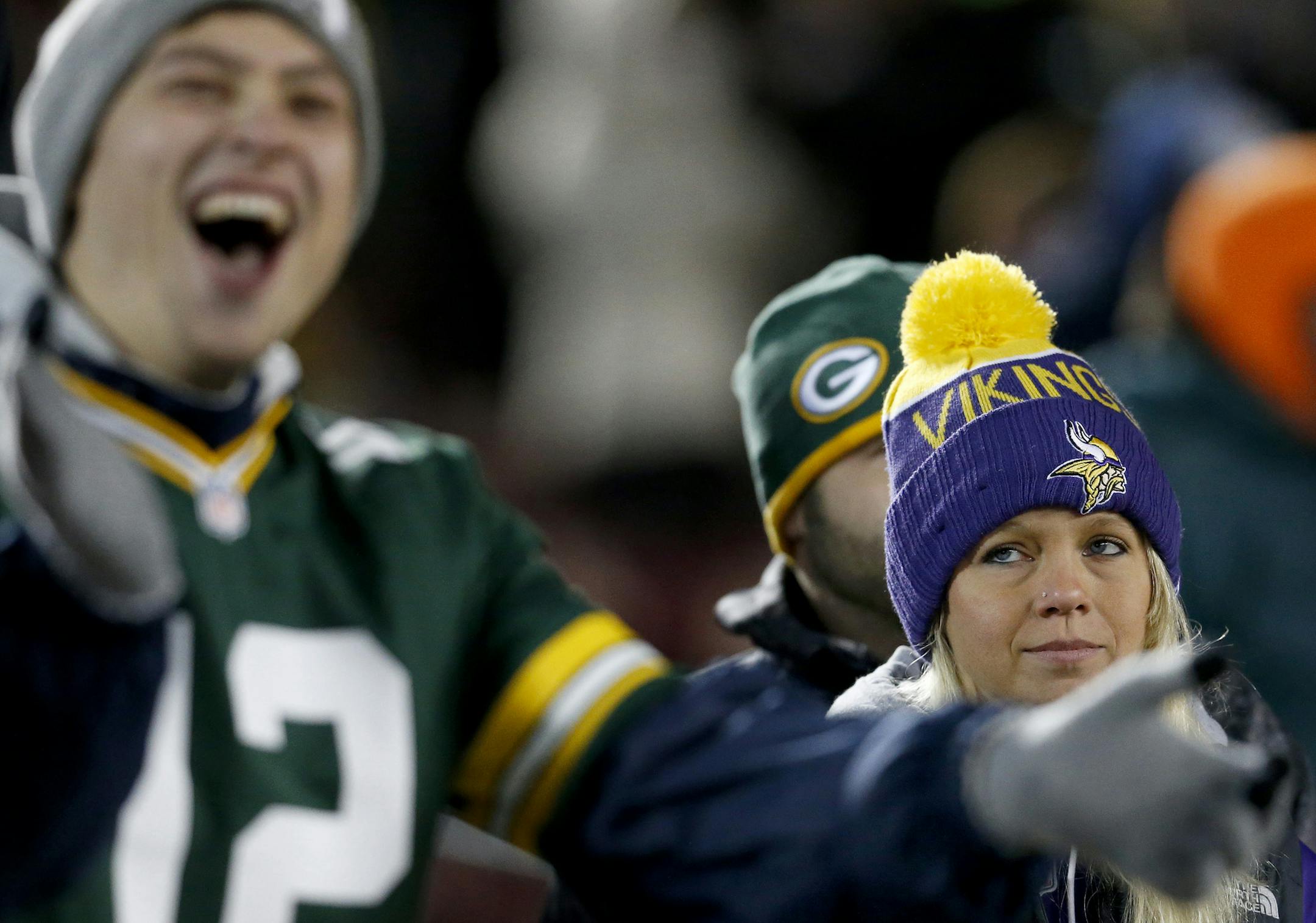 Green Bay Packers fan Mason Horacek, 24, of Yankton South Dakota cheered at the end of the game as Minnesota Vikings fan Shelly Bye, 26, had a different expression. Green Bay beat Minnesota by a finals score of 30-13. ] CARLOS GONZALEZ ï cgonzalez@startribune.com - November 22, 2015, Minneapolis, MN, TCF Bank Stadium, NFL, Minnesota Vikings vs. Green Bay Packers