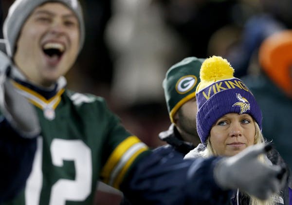 Green Bay Packers fan Mason Horacek, 24, of Yankton South Dakota cheered at the end of the game as Minnesota Vikings fan Shelly Bye, 26, had a differe