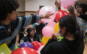 Members of World Youth Connect fill balloons during a group meeting on May 20 in St. Paul. The group, founded by Ofir Germanic and DeJiohn Brooks, lea