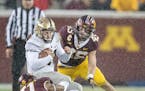 Minnesota linebackers Carter Coughlin, right, and Thomas Barber brought down Purdue quarterback David Blough during the third quarter last November at