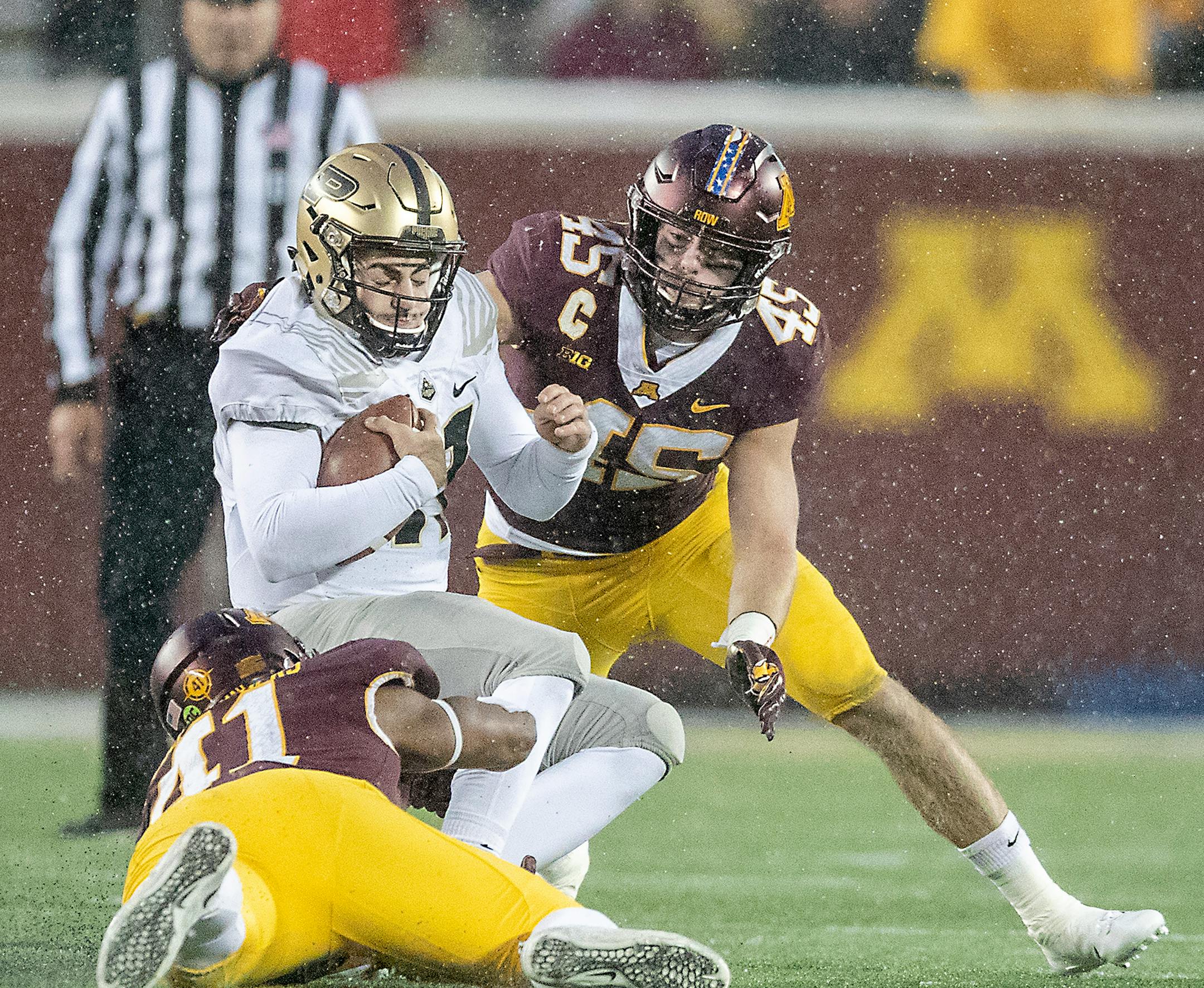 Minnesota linebackers Carter Coughlin, right, and Thomas Barber brought down Purdue quarterback David Blough during the third quarter last November at TCF Bank Stadium.