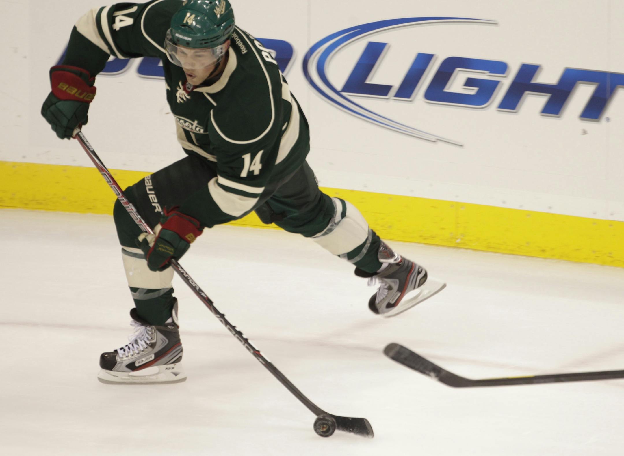 TOM WALLACE • twallace@startribune.com _ The Wild Home opener at the Xcel Center vs the Columbus Blue Jackets. Wild's, DARROLL POWE passes one to the front of the net Wild Home opener. [ _ Assignments #20019855E_ October 8, 2011_ SLUG: wild1009_ EXTRA INFORMATION: Name(CQ) from the mom.