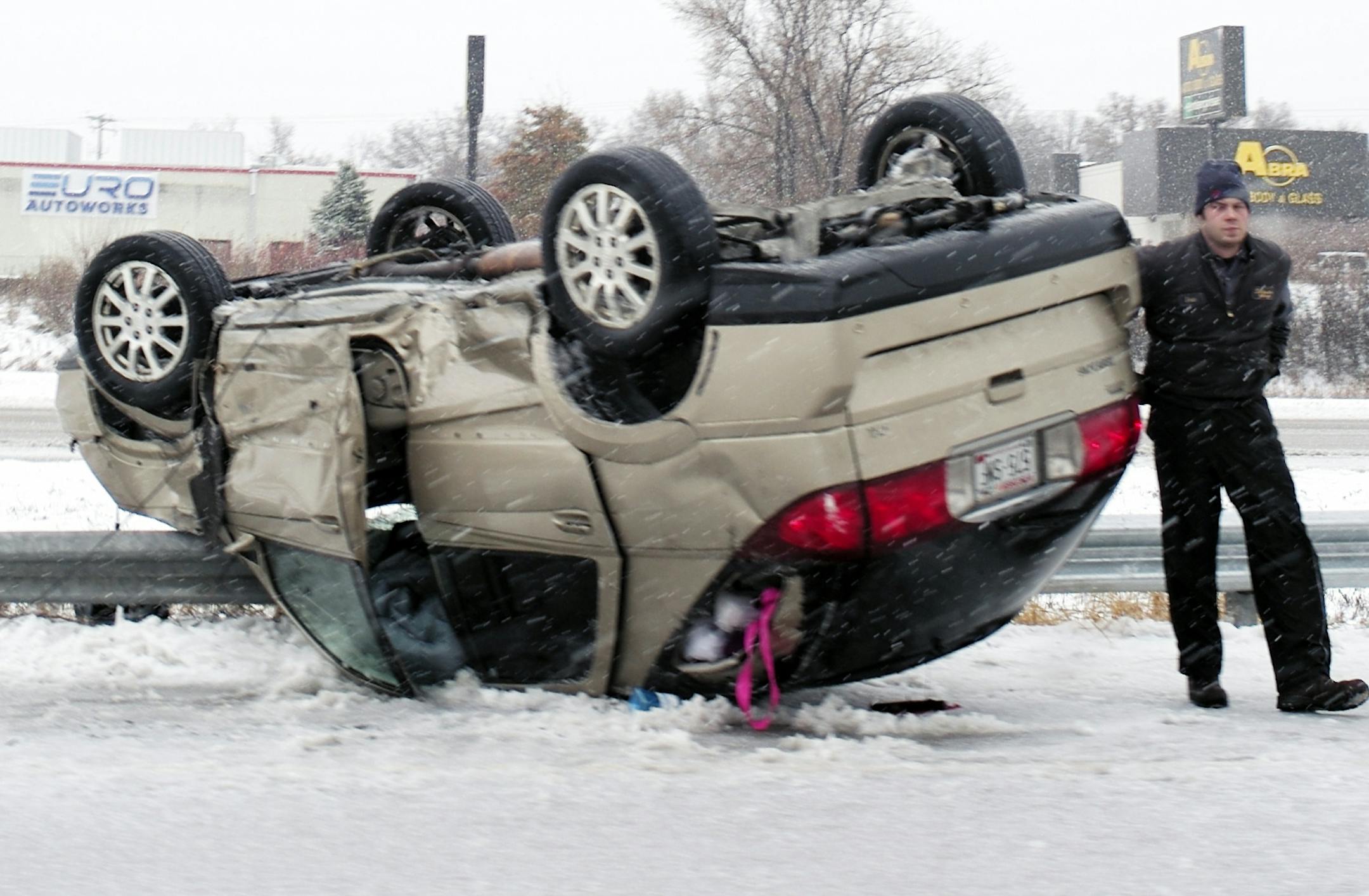 On I94 West on St. Paul near the Radio Ave exit, a tow truck service worker helps remove an overturned vehicle.]richard tsong-taatarii/rtsong-taatarii@startribune.com