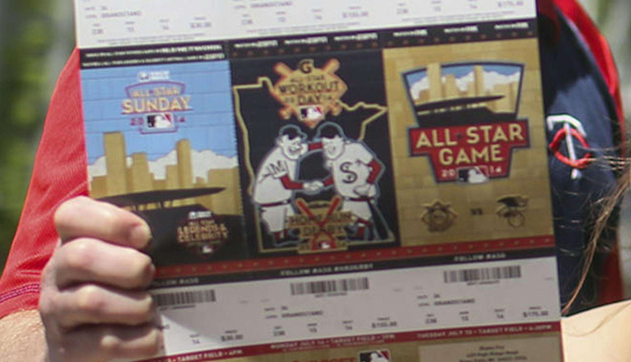 Blake Fry and his wife Michele, hold on to their coveted All-Star Game tickets before heading to watch the Twins take on the New York Yankees with their children Liam, 7, and Abby, 11, Friday, July 4, 2014, at Target Field in Minneapolis, MN. The Fry family is from River Falls, WI. Blake Fry, who is a partial season ticket holder, has been to about 700 Major League baseball games but this will be his first All-Star game.] (DAVID JOLES/STARTRIBUNE) djoles@startribune Tickets for the Major League