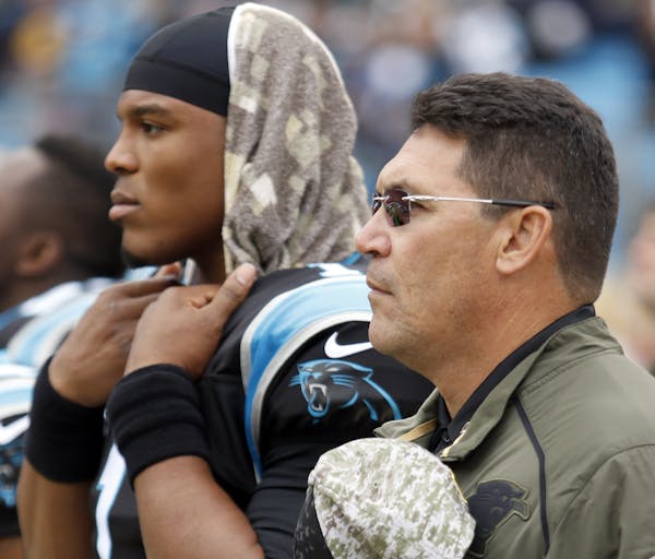 Carolina Panthers' Cam Newton (1) and head coach Ron Rivera during the National Anthem before an NFL football game against the Green Bay Packers in Ch