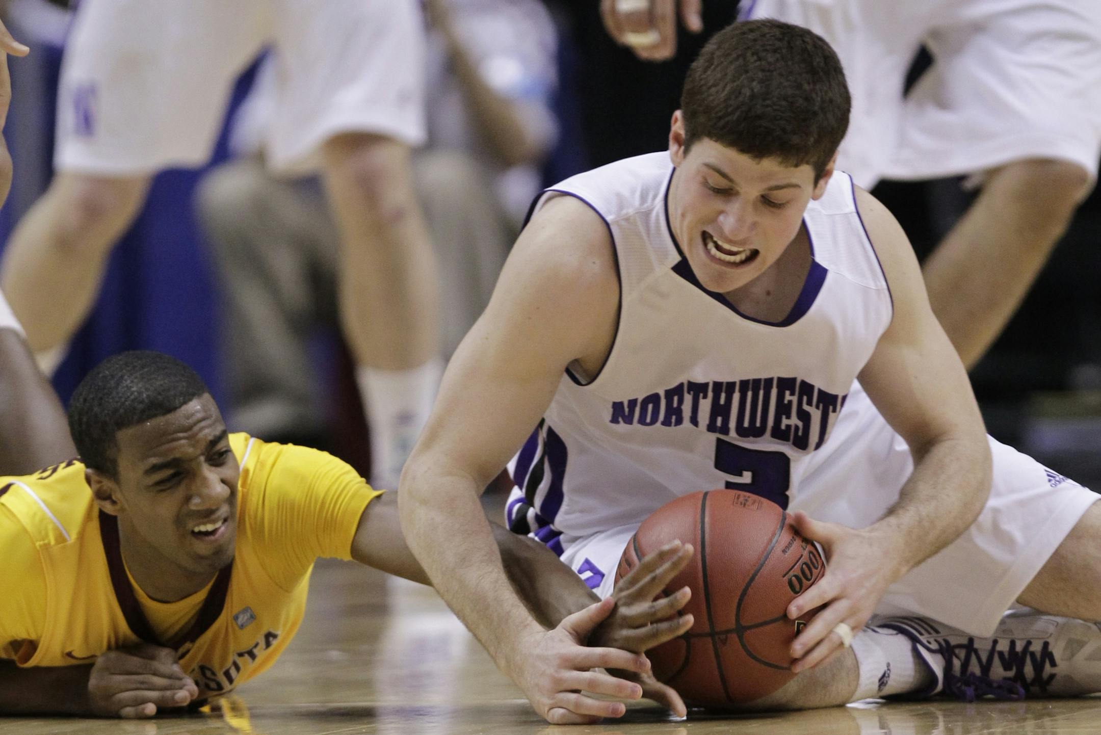 Northwestern guard Dave Sobolewski, right, and Minnesota guard Austin Hollins battle for a loose ball in the first half of an NCAA college basketball game at the first round of the Big Ten Conference tournament in Indianapolis, Thursday, March 8, 2012.