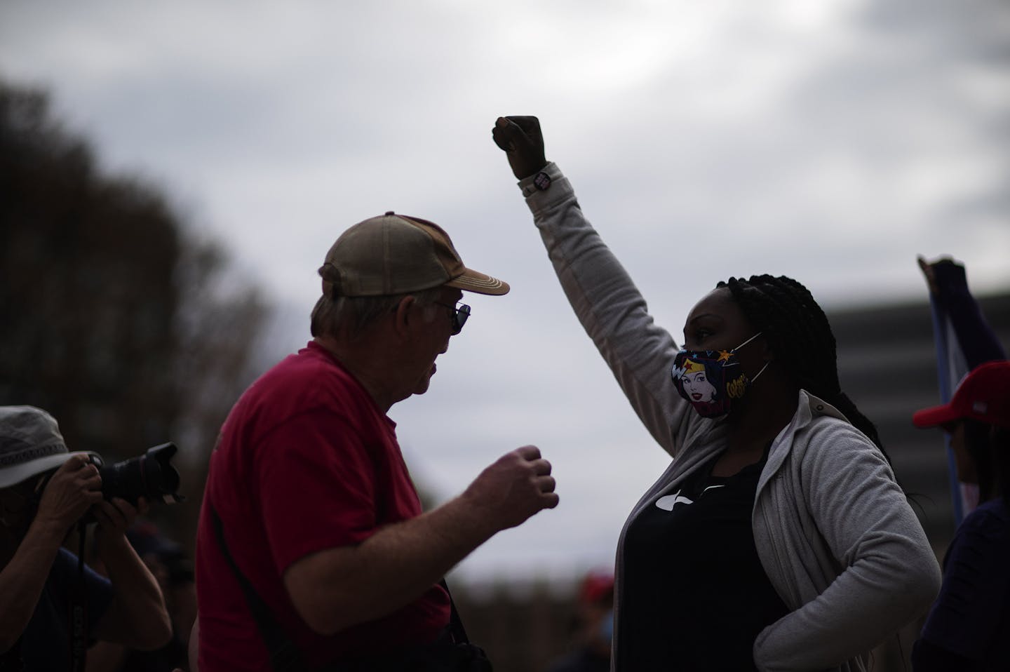 A Trump supporter, at left, demonstrating against the presidential election results, argues with a counter protestor at the State Capitol in Lansing, Mich., Sunday, Nov. 8, 2020. (AP Photo/David Goldman)