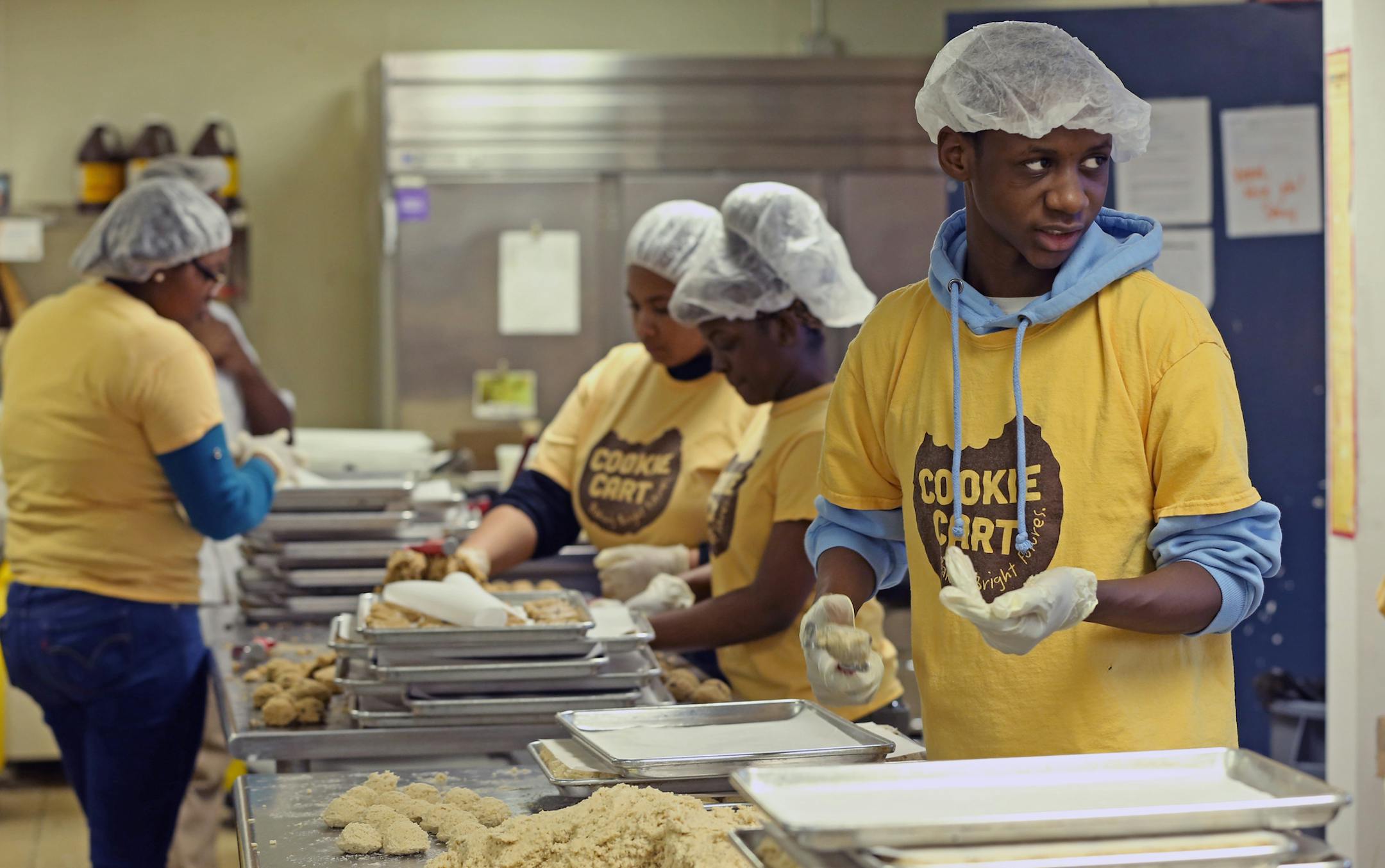 (right) Omar Pope made coconut cookies at the Cookie Cart on 2/6/14. The Cookie Cart is a fixture of north Minneapolis, a program that teaches high-school kids bakery and life skills. Photographed on 2/6/14.] Bruce Bisping/Star Tribune bbisping@startribune.com Omar Pope/source.