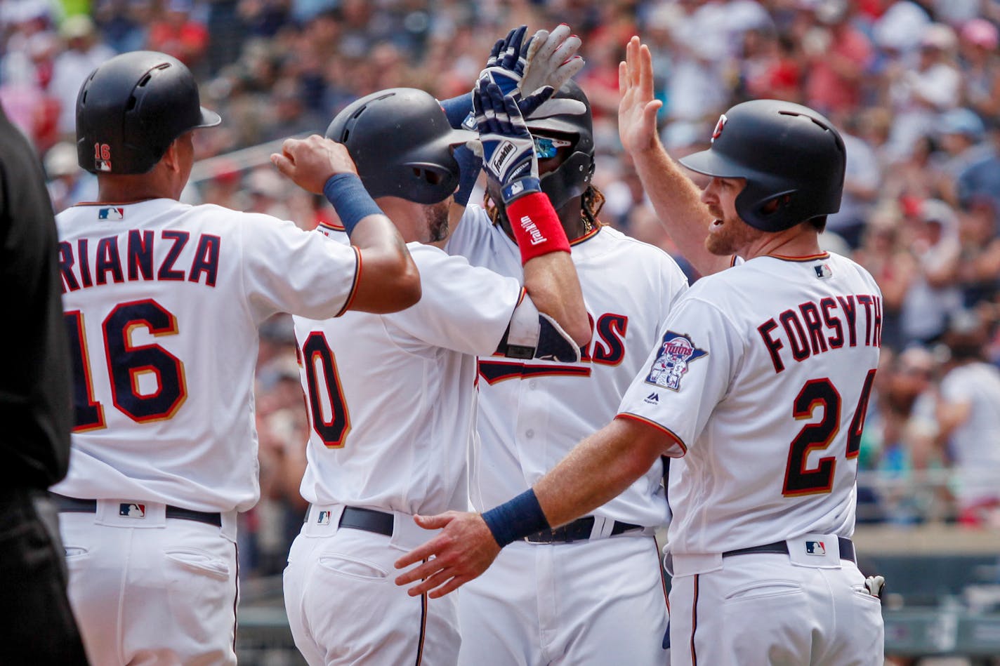 Minnesota Twins Jake Cave celebrates his grand slam with Ehire Adrianza (16), Miguel Sano (22), and Logan Forsythe (24) against the Kansas City Royals in the second inning of a baseball game Sunday, Aug. 5, 2018, in Minneapolis. (AP Photo/Bruce Kluckhohn)