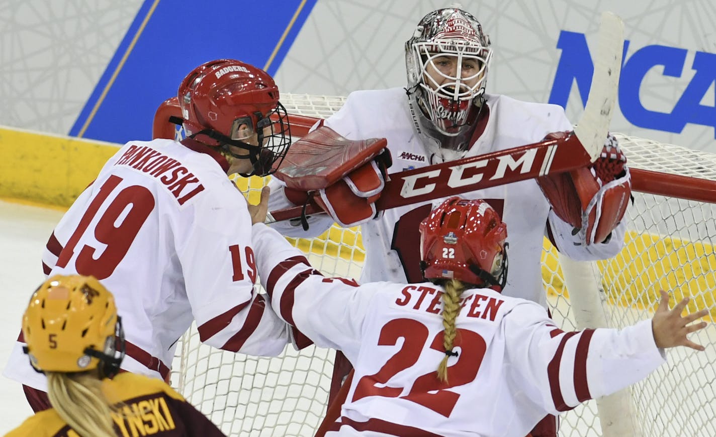 Wisconsin goaltender Kristen Campbell (35) is greeted by teammates Annie Pankowski (19) and Mekenzie Steffen (22) as they defeat Minnesota for the NCAA Division I women's Frozen Four hockey championship game, Sunday, March 24, 2019, in Hamden, Conn. (AP Photo/Stephen Dunn)