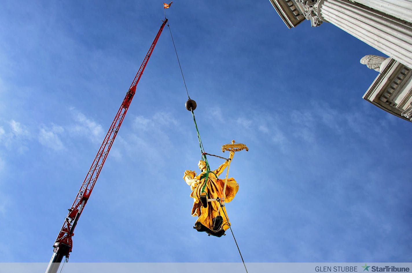 The charioteer figure who guides the golden horses on the Minnesota State Capitol Building's Quadriga statue were temporarily removed on Tuesday, September 23 to repair corrosion discovered at the statue's base. The repair is expected to take approximately three months when charioteer will return to the Quadriga.    ]   Tuesday, September  23, 2014   GLEN STUBBE * gstubbe@startribune.com