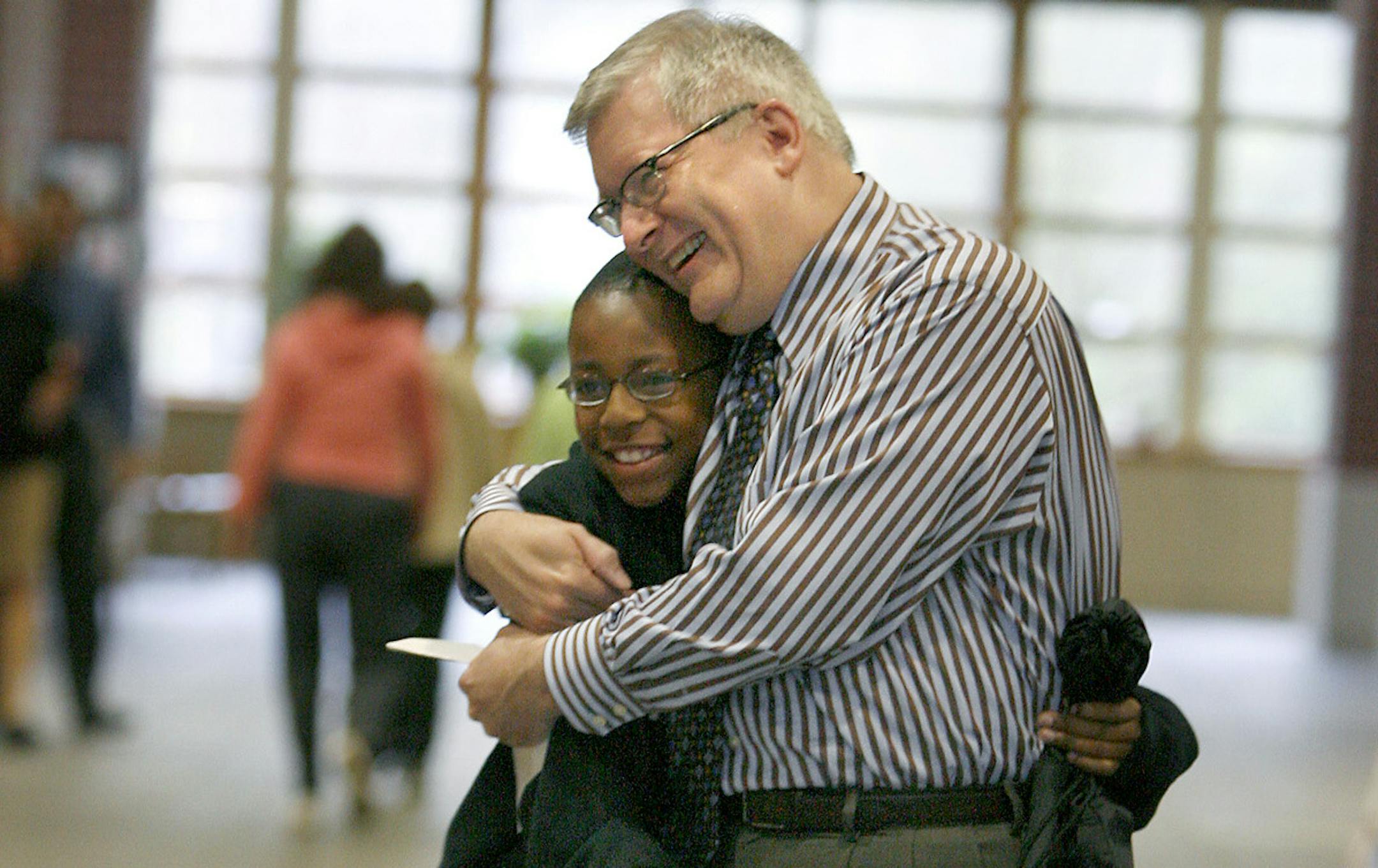 ELIZABETH FLORESï eflores@startribune.com May 5, 2009 - Minneapolis, MN - Burroughs Community School Principal Tim Cadotte was greeted with hugs by his students as they made their way to class early Tuesday morning on Cadotte's first day back to school after a suspension following an altercation iwth a school board memeber.