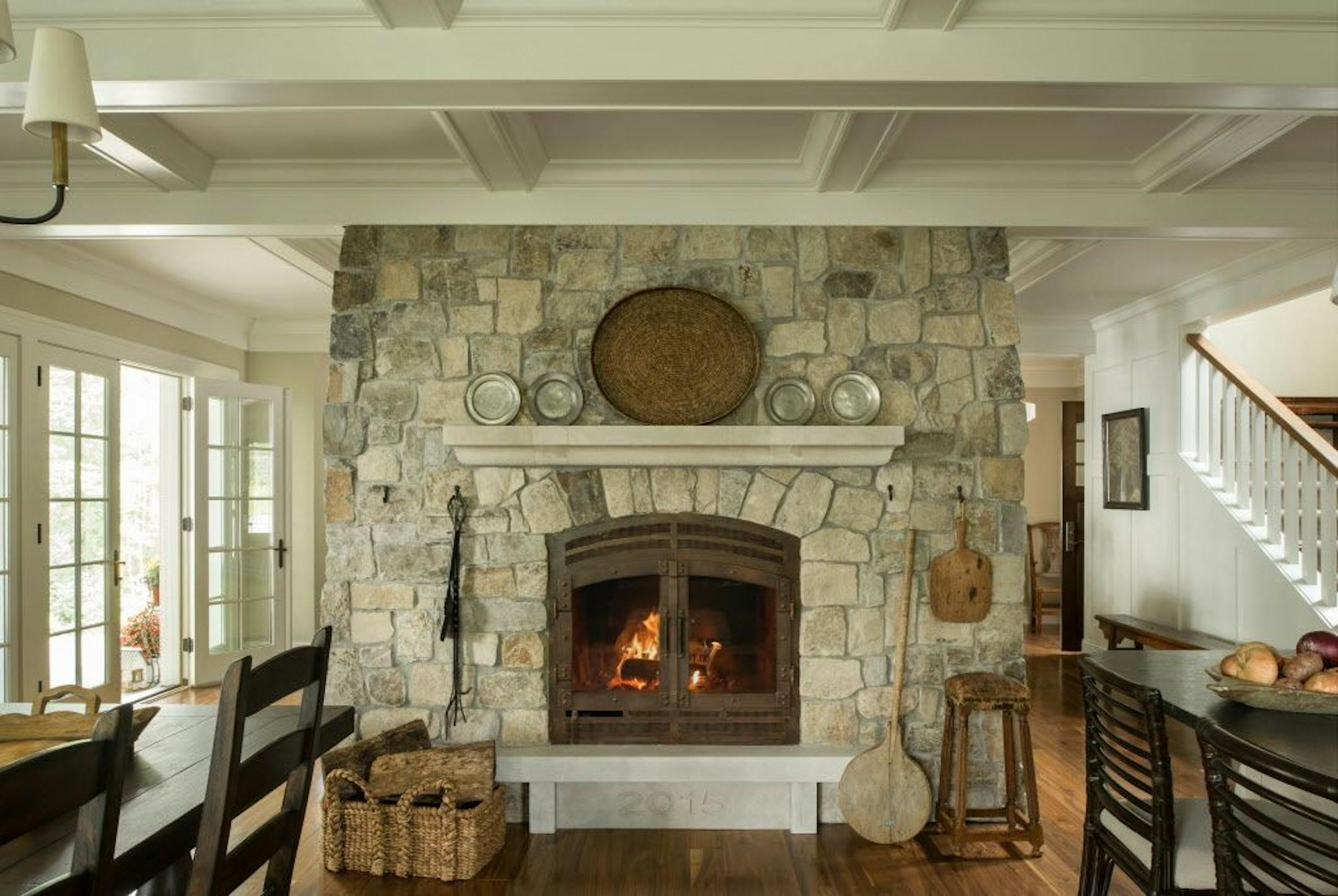 Dramatic two-sided stone fireplace inside a new Lake Superior retreat, by Mark Larson, Rehkamp Larson Architects.