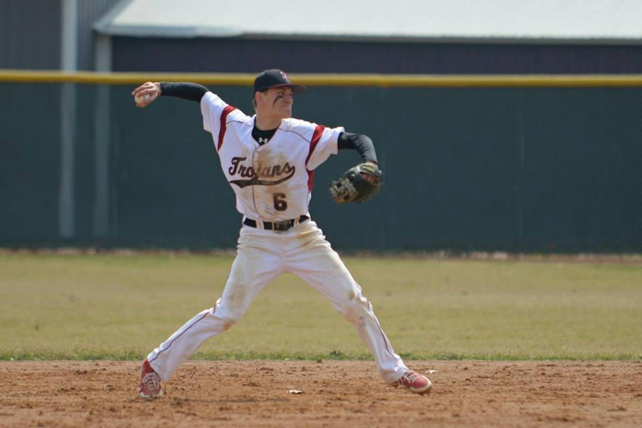 New Prague shortstop Auggie Isaacson prepares to throw a runner out at first base after fielding a ground ball cleanly.