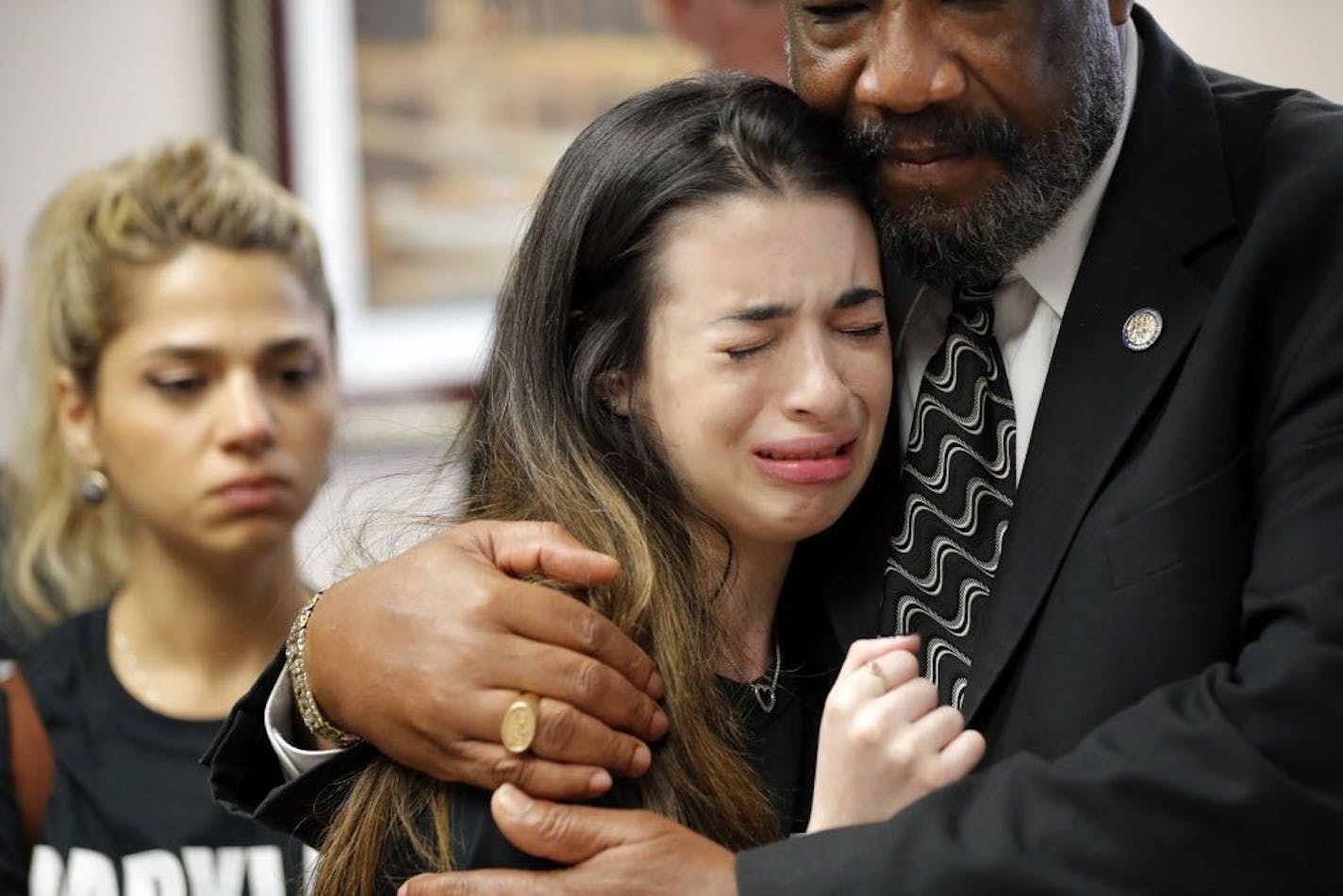 Aria Siccone, 14, a 9th grade student survivor from Marjory Stoneman Douglas High School, where more than a dozen students and faculty were killed in a mass shooting on Wednesday, cries as she recounts her story from that day, while state Rep. Barrinton Russell, D-Dist. 95, comforts her, as they talk to legislators at the state Capitol regarding gun control legislation, in Tallahassee, Fla., Wednesday, Feb. 21, 2018.