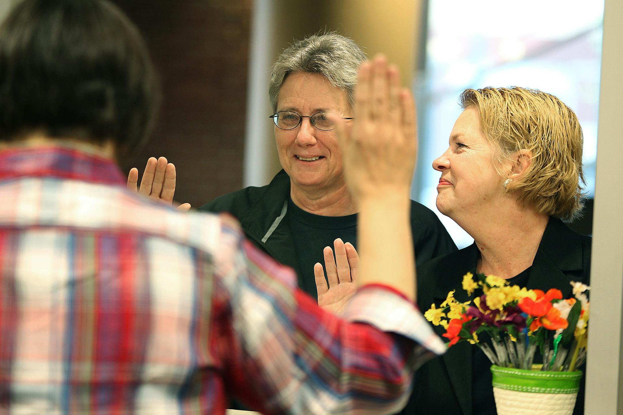 Doreen Pippenger, left, and Dawn Metcalf of St. Paul, MN, applied for marriage license under oath at the Ramsey County Public Health Center, Thursday, June 6, 2013. (ELIZABETH FLORES/STAR TRIBUNE) ELIZABETH FLORES • eflores@startribune.com