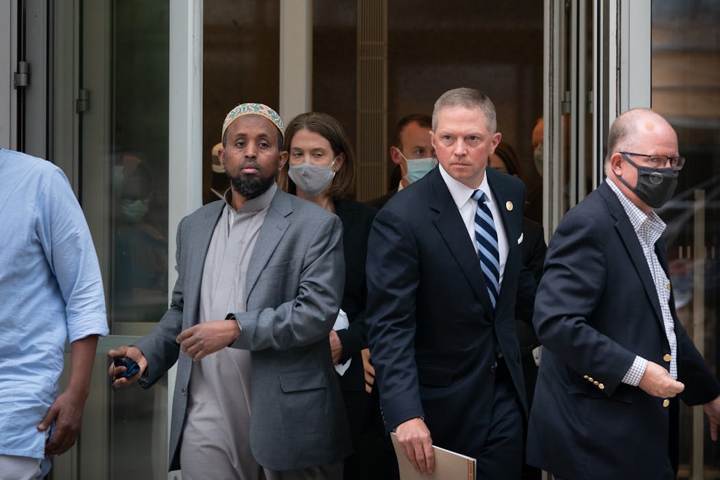 Imam Mohamed Omar, left, and Anders Folk, then the acting U.S. Attorney for Minnesota, emerged from the federal courthouse last September after a judge sentenced Emily Hari to 53 years in prison for orchestrating the bombing of Omar’s mosque. 