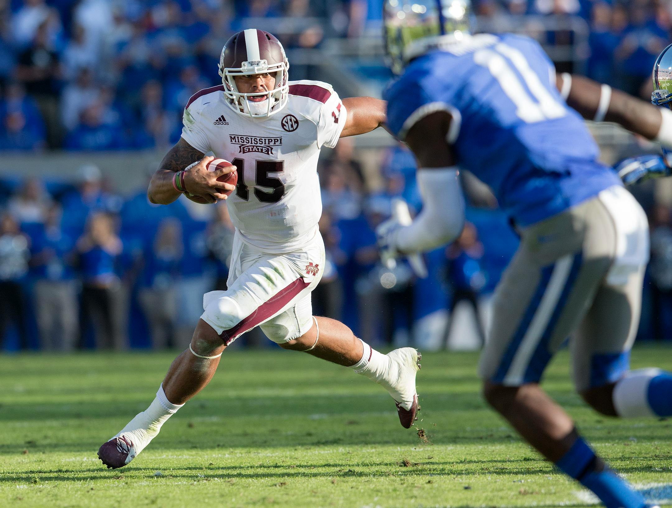 Mississippi State quarterback Dak Prescott scrambles out of the pocket during the first half of an NCAA college football game against Kentucky at Commonwealth Stadium in Lexington, Ky., Saturday, Oct. 25, 2014. Mississippi State beat Kentucky 45-31. (AP Photo/David Stephenson)