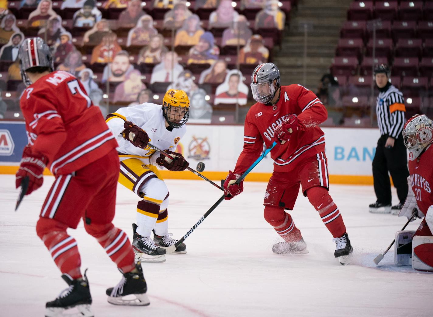 Minnesota Gophers forward Jonny Sorenson (11) kept his eye on an incoming puck in the first period, as did the Buckeyes' Grant Gabriele (61). ] JEFF WHEELER • jeff.wheeler@startribune.com