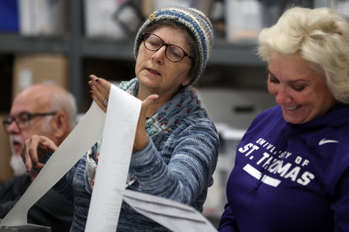 Jane Strauss, left, and Tracy Armstrong looked through a voter printout as they helped test Minneapolis' electronic voting system Tuesday. ] ANTHONY SOUFFLE &#xef; anthony.souffle@startribune.com Minneapolis city staff tested a randomly selected assortment of voting machines to demonstrate the accuracy of the computer program, voting equipment and ballots Tuesday, Oct. 31, 2017 at an equipment storage center in Northeast Minneapolis.