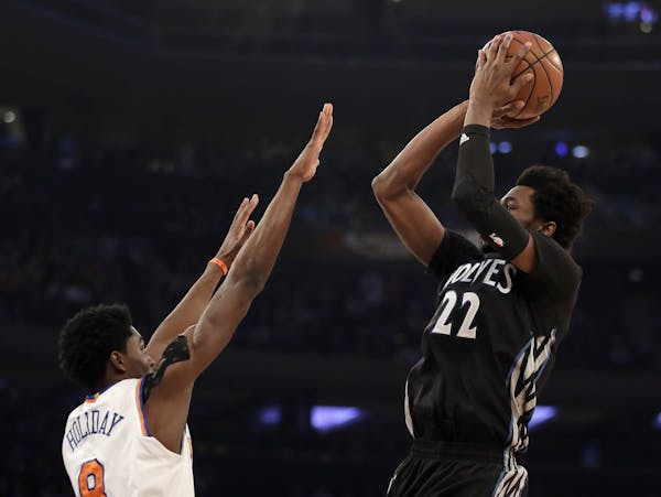 Minnesota Timberwolves forward Andrew Wiggins (22) shoots against New York Knicks guard Justin Holiday (8) during the first half of an NBA basketball 