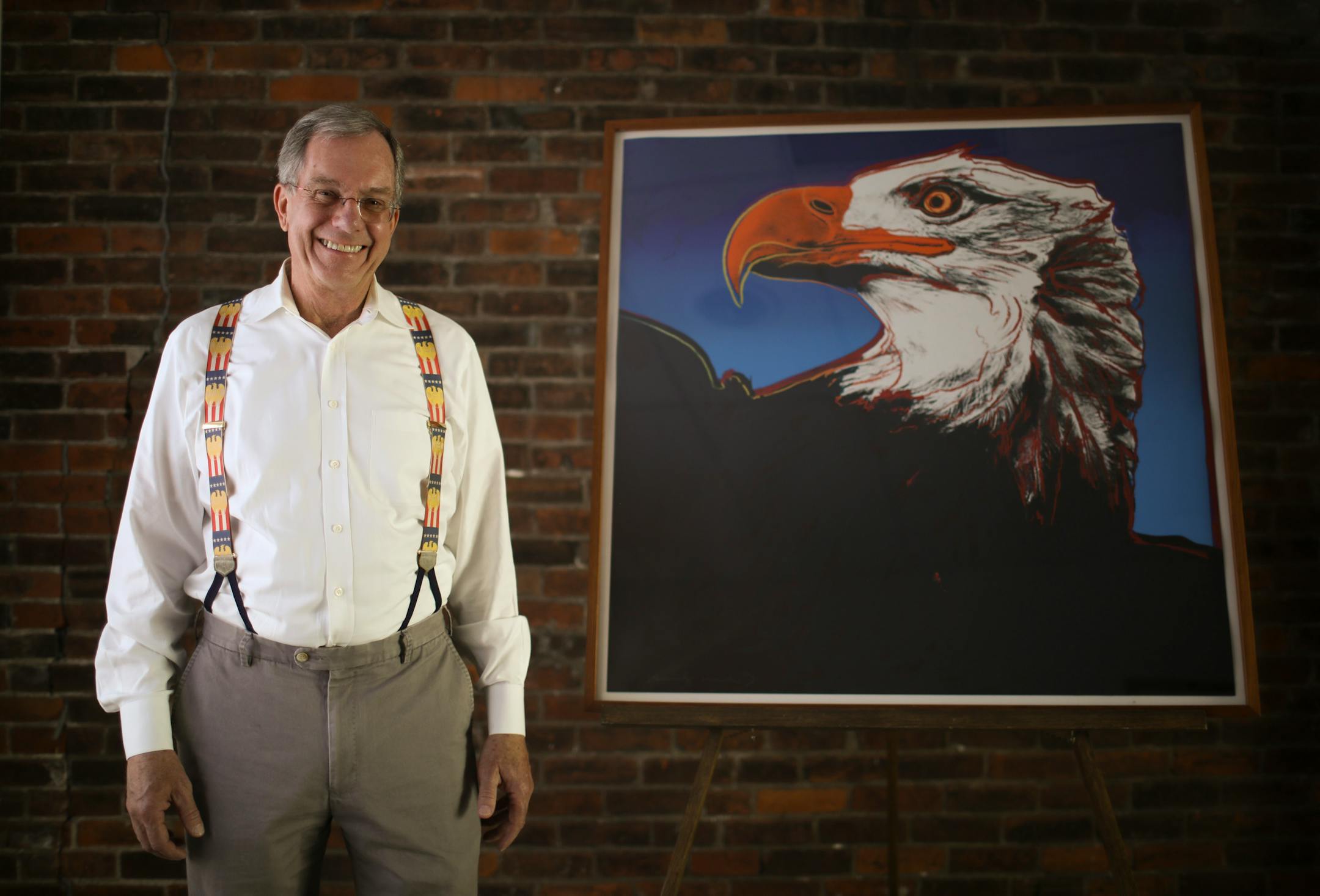 Preston Cook with Andy Warhol's 1983 screenprint "Bald Eagle" in one of the buildings that the National Eagle Center has plans to renovate, in part to display Cook's collection of eagle fine art.