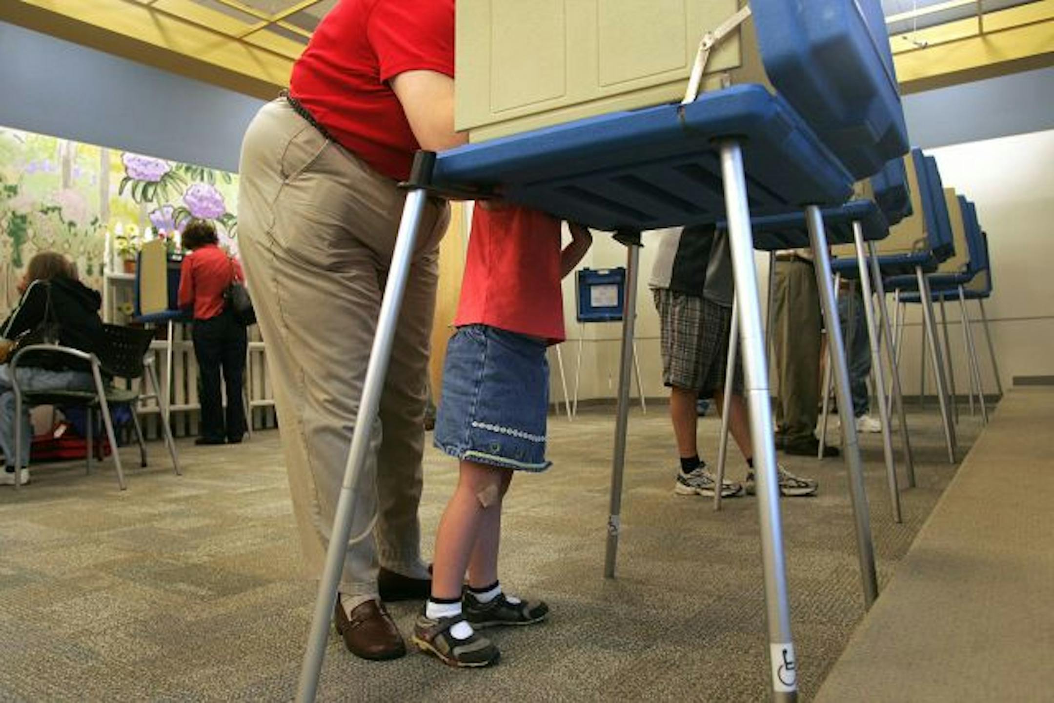 Laura Hensey, left, has her daughter Erin, 4 help her in the voting booth as she cast her ballot in the North Carolina Primary at the Cameron Village Library in Raleigh, N.C., Tuesday, May 6, 2008.