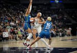 Las Vegas Aces center A'ja Wilson tries to squeeze between Lynx forward Napheesa Collier, left, and guard Courtney Williams on her way to the basket i