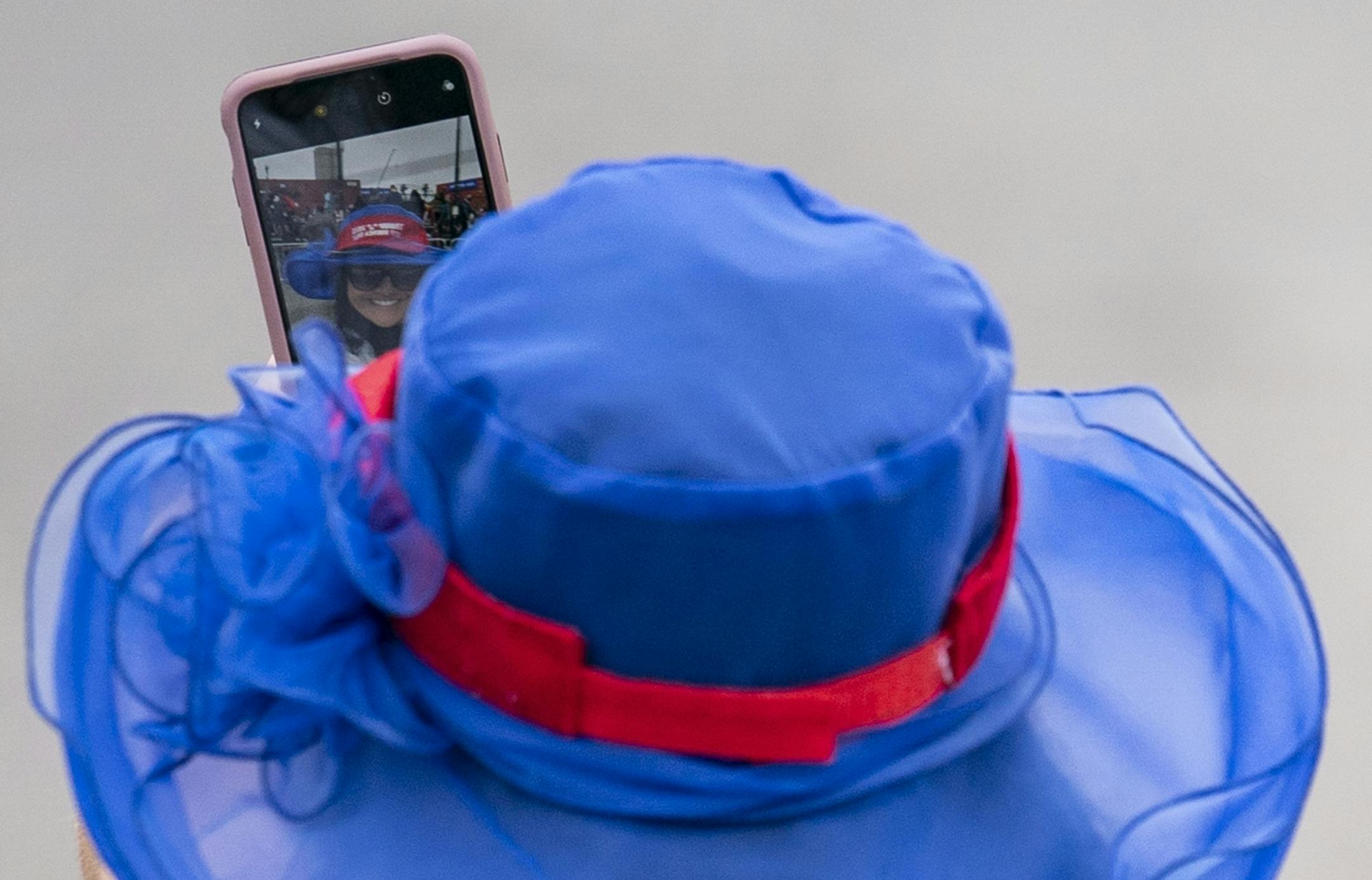 A woman took a selfie behind the crowd while she waited for Vice President Mike Pence speak in Duluth on Friday.