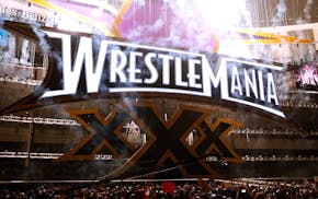 Fireworks are seen on the main stage as Wrestlemania XXX begins at the Mercedes-Benz Super Dome in New Orleans on Sunday, April 6, 2014. (Jonathan Bac