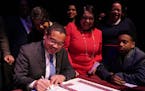 Attorney General Keith Ellison signed the paperwork to make it official after he took the oath of office at the Fitzgerald Theater in St. Paul.