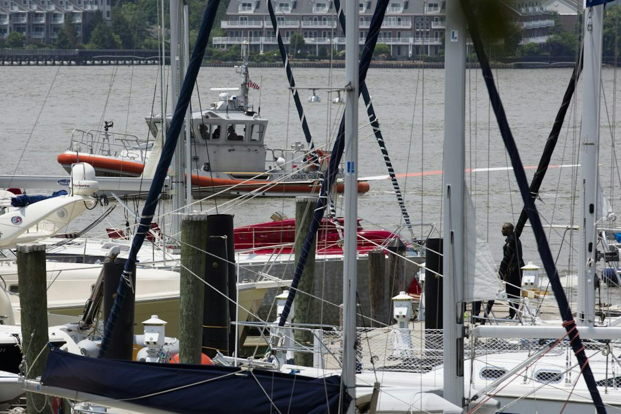 A helicopter rests on a pontoon at the 79th Street Boat Basin after emergency landing over the Hudson river, Sunday, June 30, 2013, in New York. New York authorities say a helicopter carrying four Swedish tourists has landed in the Hudson River off Manhattan, but everyone has been rescued. The incident happened shortly before noon Sunday in the section of the river near 79th Street. The pilot and four passengers were taken to shore.