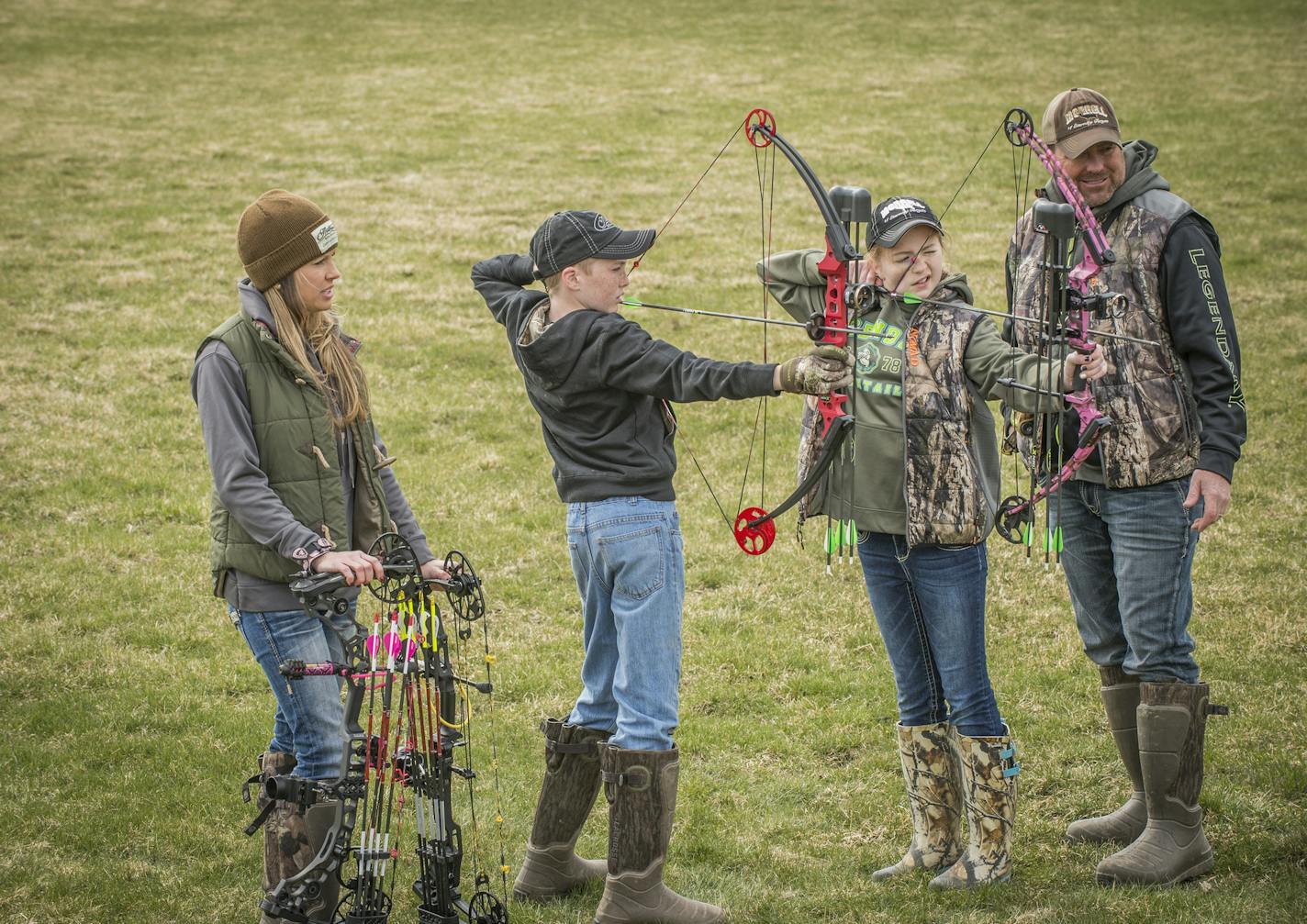 Pat and Nicole Reeve, who live near Plainview in southeast Minnesota, and who host the outdoor television show, "Driven with Pat & Nicole'' on the Outdoor Channel. Here they're practicing with their bows with two of their children