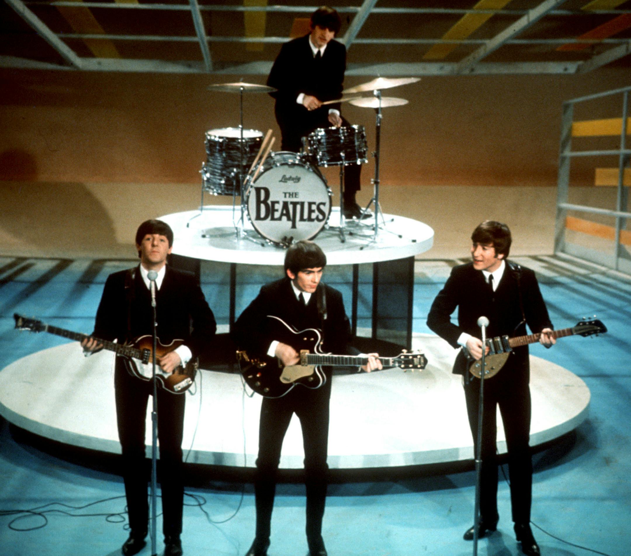 FILE - In this Feb. 9, 1964 file photo, The Beatles perform on the CBS "Ed Sullivan Show" in New York. They love us, yeah! yeah! yeah! At 12:01 a.m. local time on Dec. 24, 2015, around the world, the Beatles' music will be available for streaming from a wide range of outlets, a representative announced Wednesday, Dec. 23. (AP Photo, File)