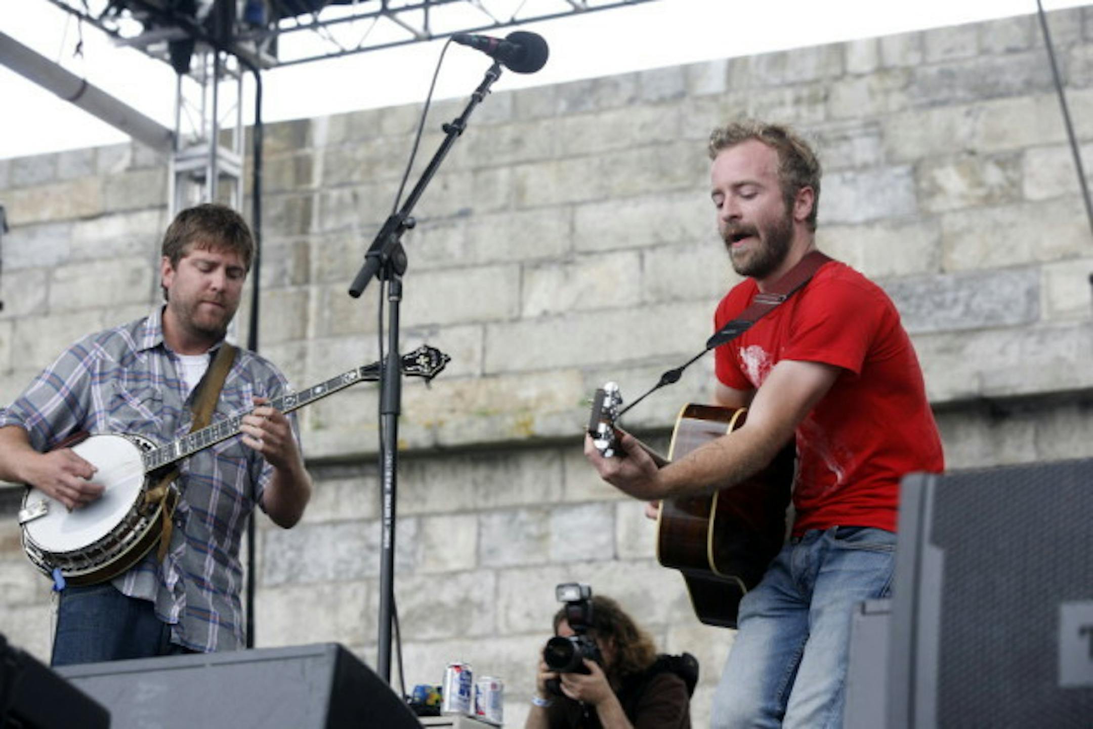 Dave Carroll, left, and Dave Simonett of Trampled by Turtles and their PBRs at the Newport Folk Festival last summer. / Joe Giblin, Associated Press
