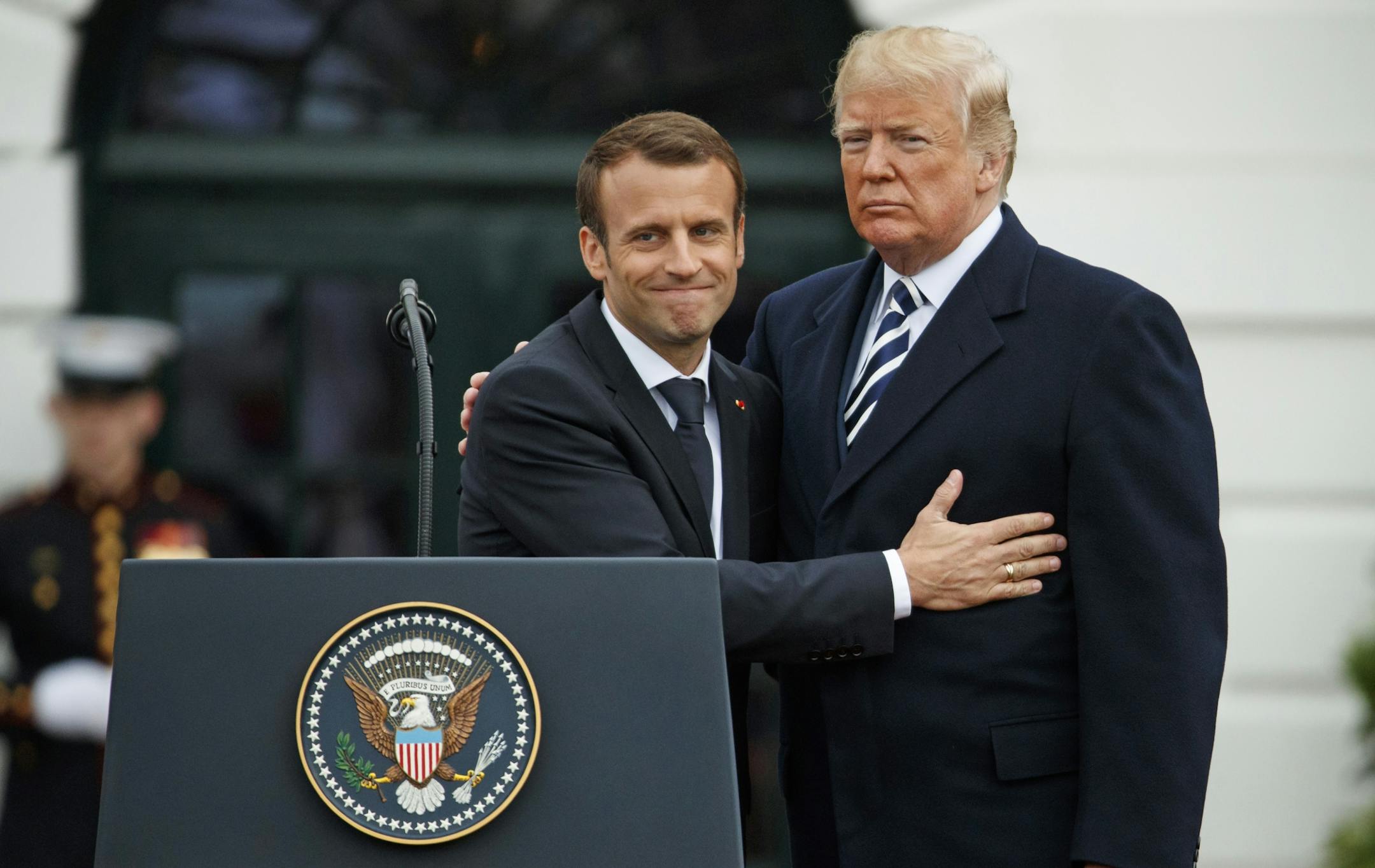 French President Emmanuel Macron hugs President Donald Trump during a State Arrival Ceremony on the South Lawn of the White House, Tuesday, April 24, 2018, in Washington.